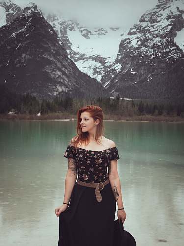 clothing woman wearing black and red floral off-shoulder blouse and black skirt apparel